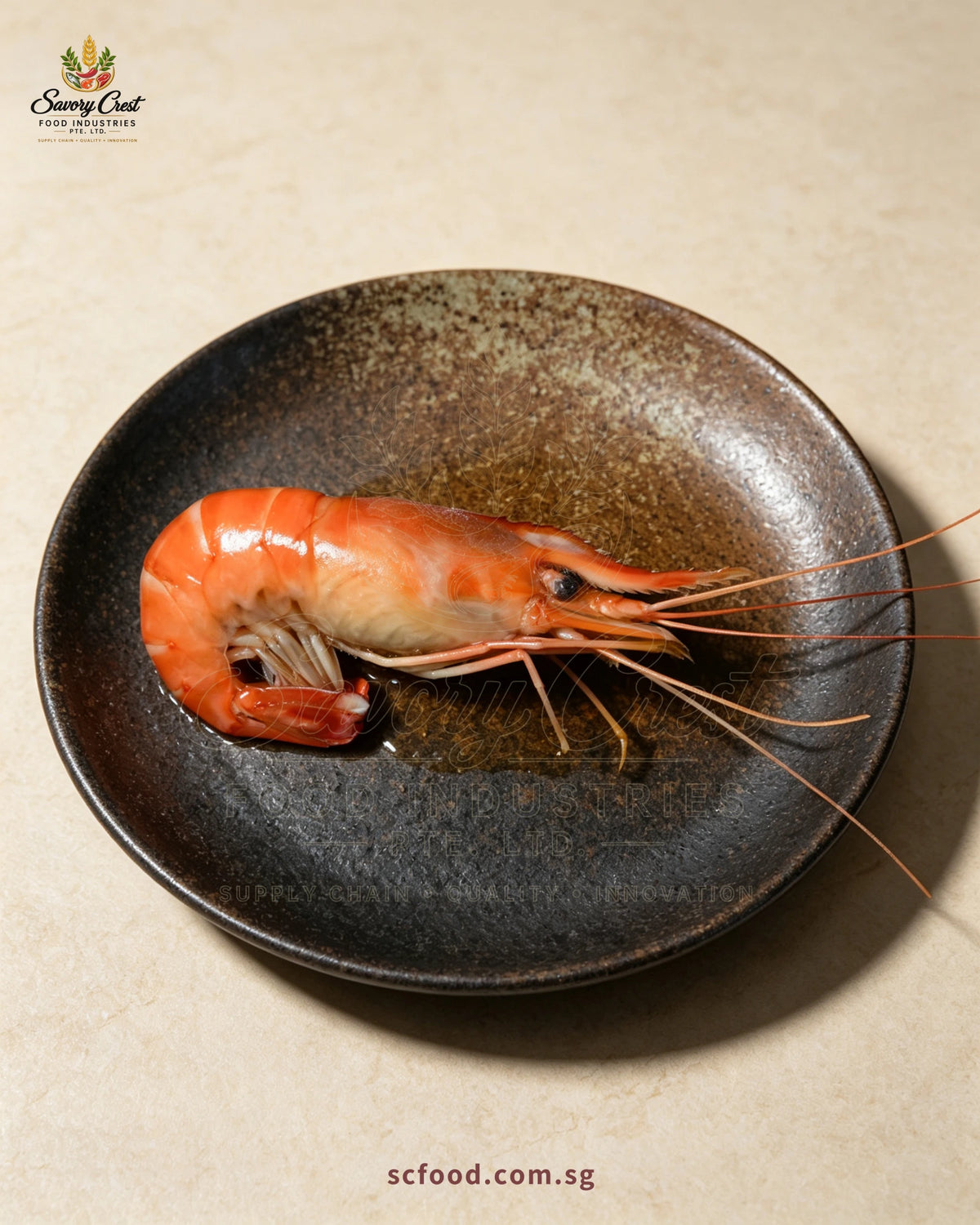 A single Huadiao drunken river prawn with sauce in a dark ceramic dish.